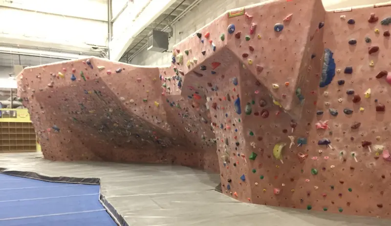The bouldering wall and its padded landing surface