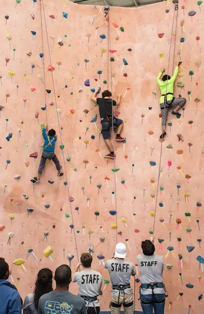 Young climbers on the wall with DRG staff belaying